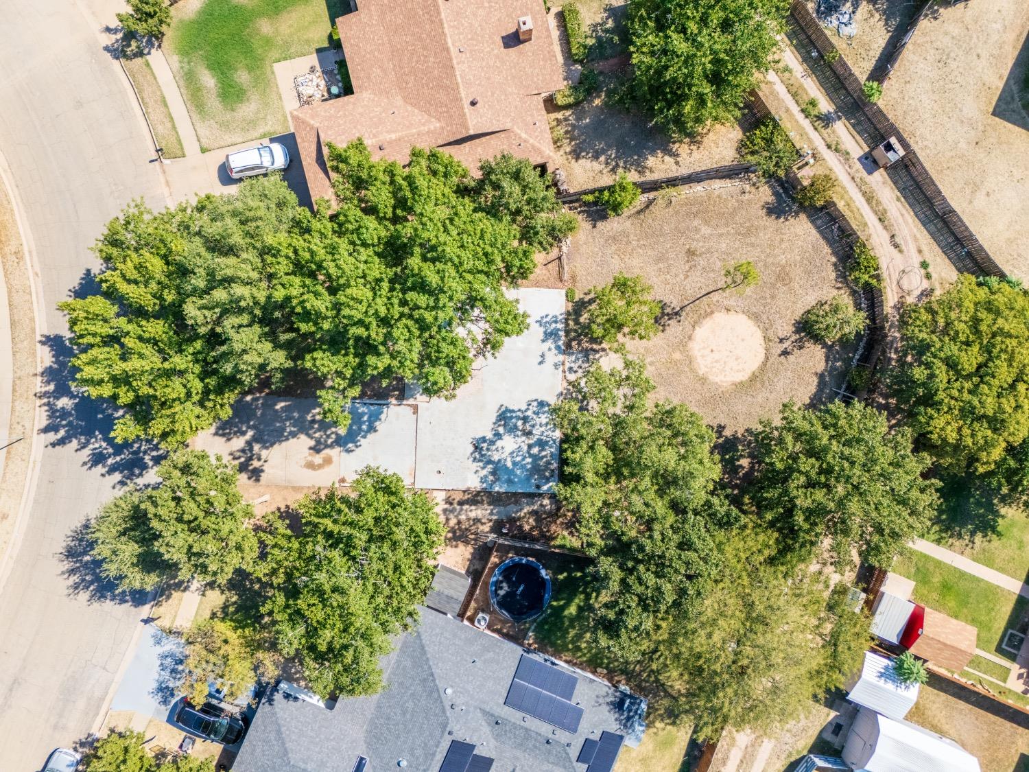 an aerial view of a house with a yard and garden