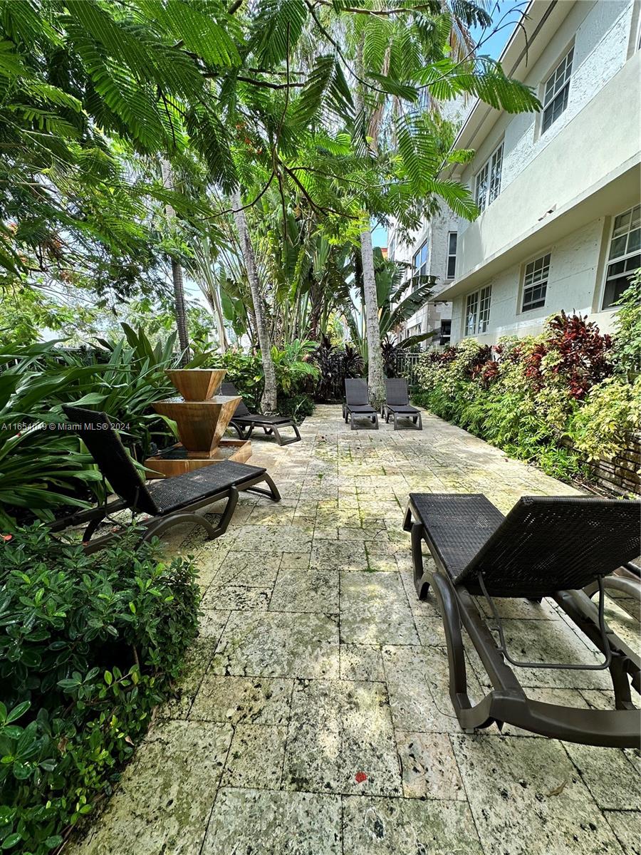 a backyard of a house with table and chairs