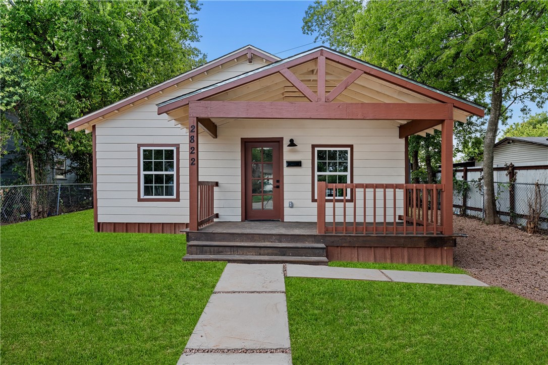 a view of a house with a yard and deck