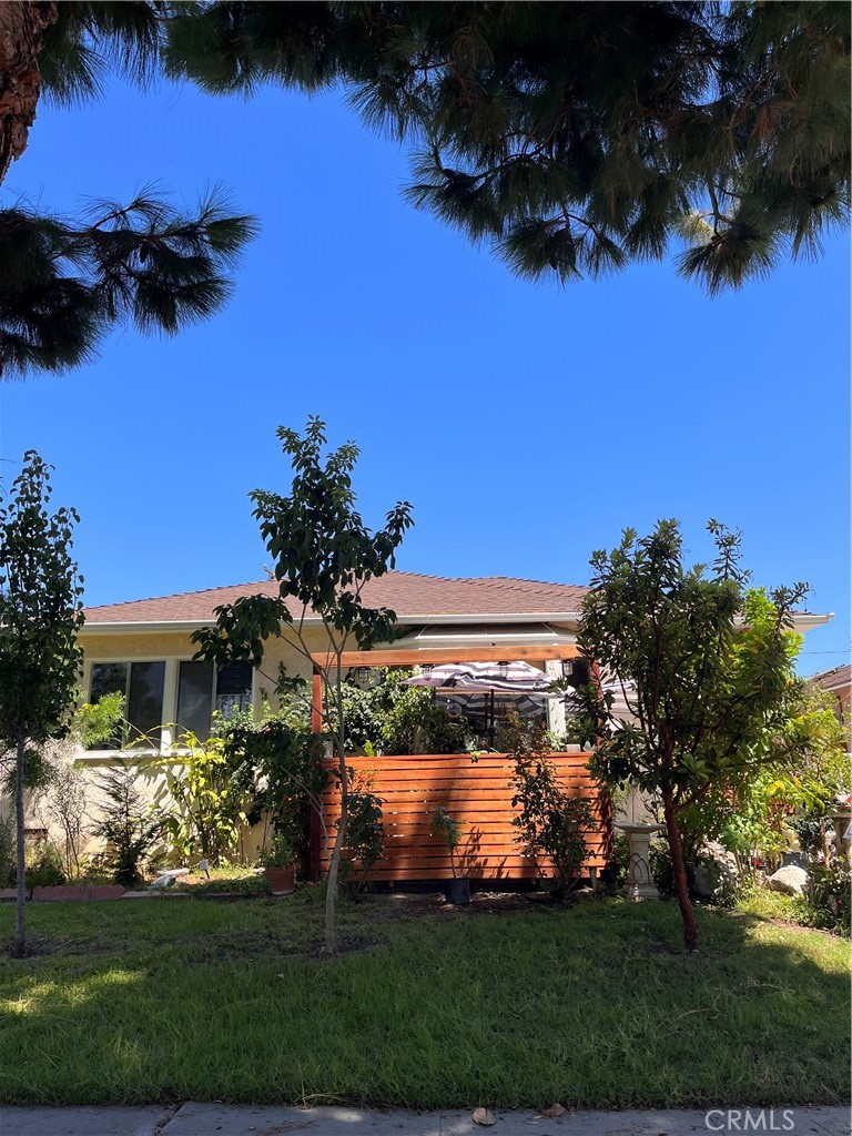 a front view of a house with a yard swimming pool and outdoor seating