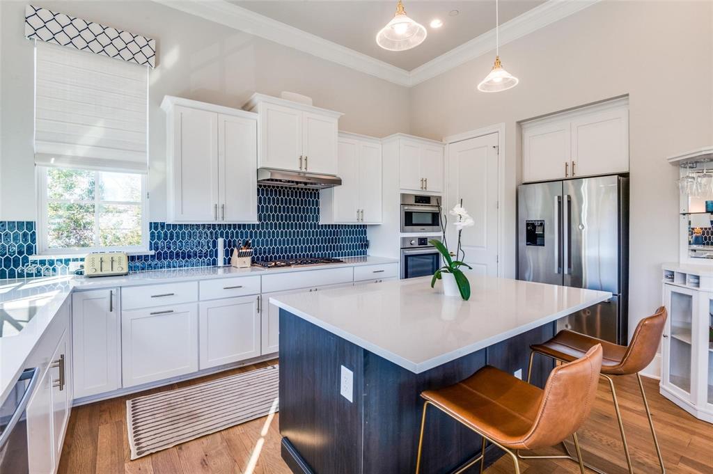 a kitchen with stainless steel appliances granite countertop a sink refrigerator and cabinets