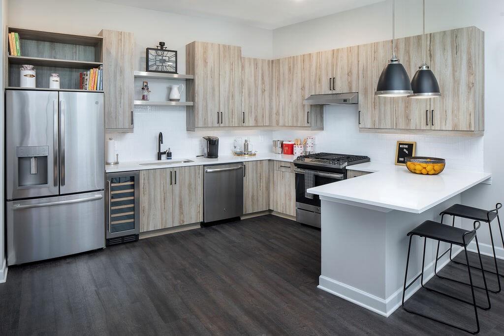 a kitchen with stainless steel appliances a sink a stove a refrigerator and cabinets