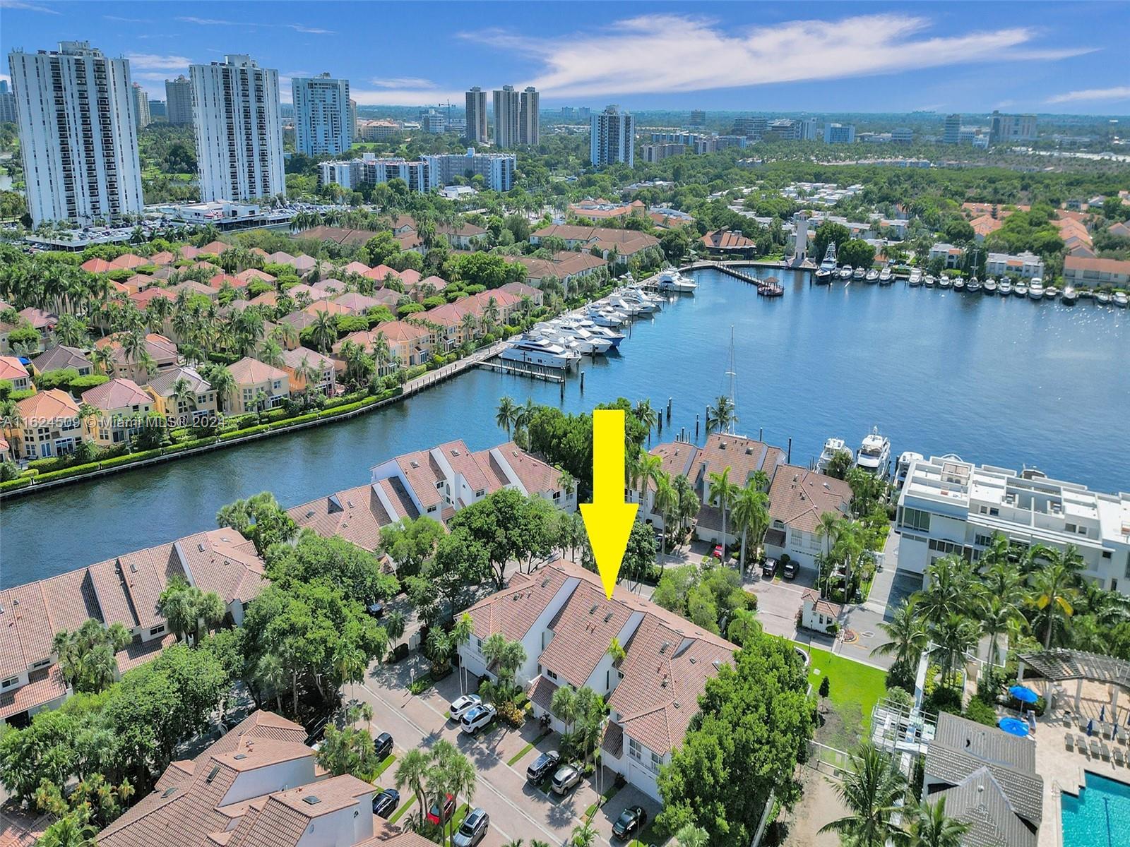 an aerial view of residential houses with outdoor space and lake view