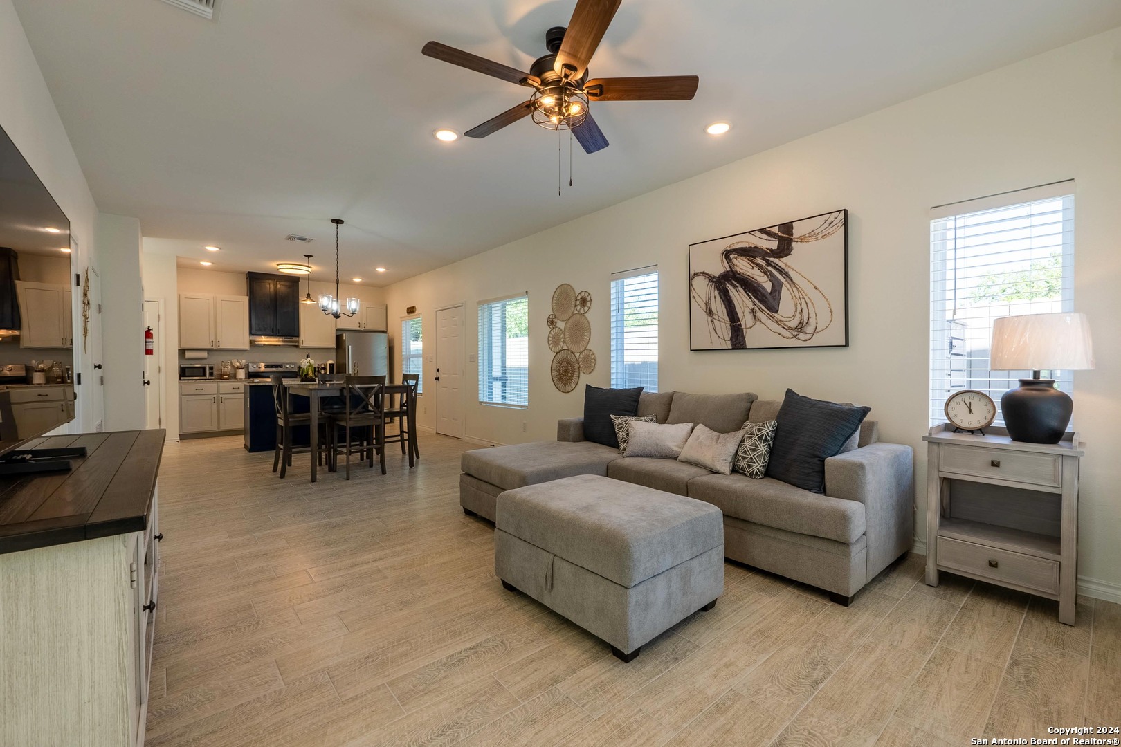 a living room with furniture and kitchen view