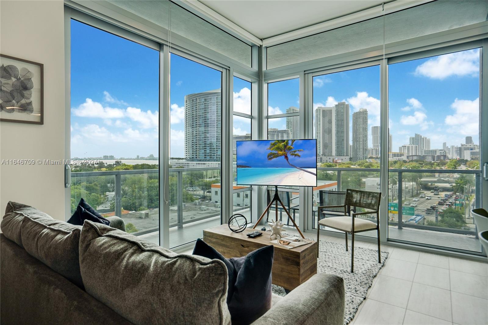 a living room with furniture and a floor to ceiling window