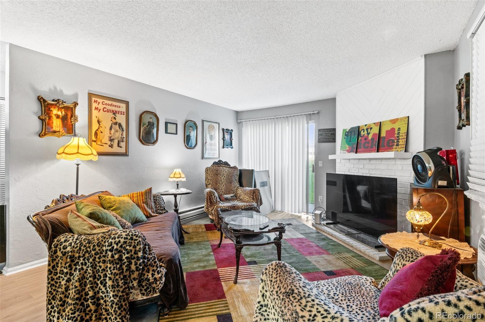 a living room with furniture fireplace and window