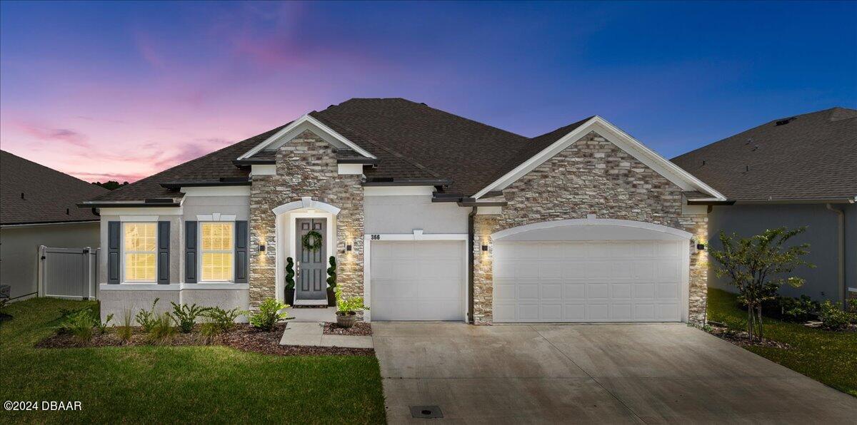 a front view of a house with a yard