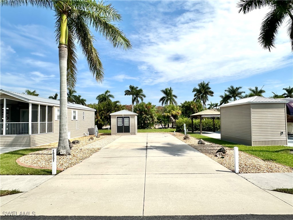 a row of palm trees and building in the background