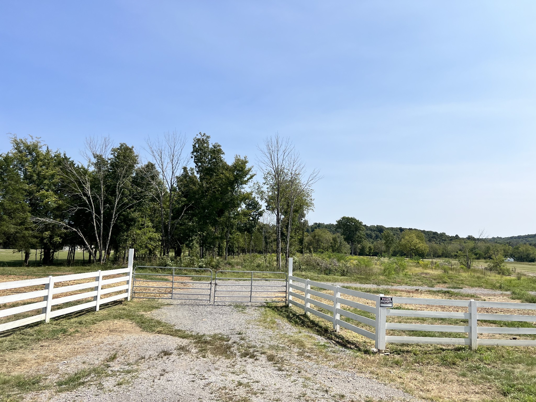 a view of a yard with wooden fence