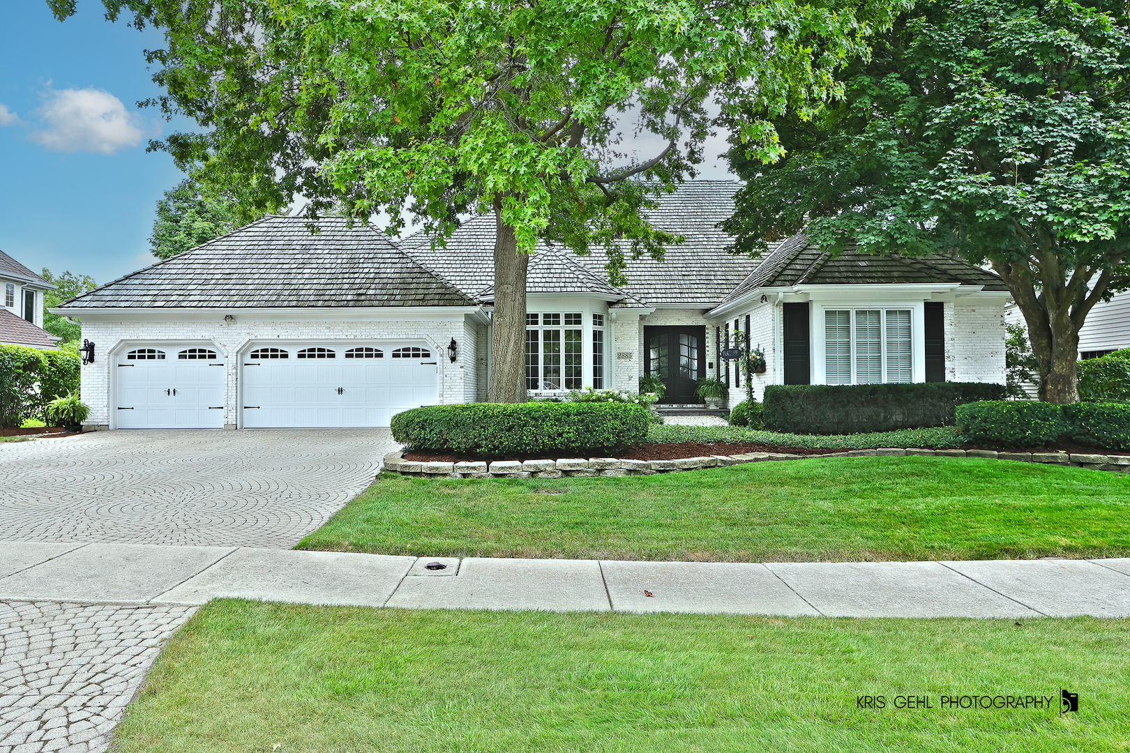 a front view of a house with a garden