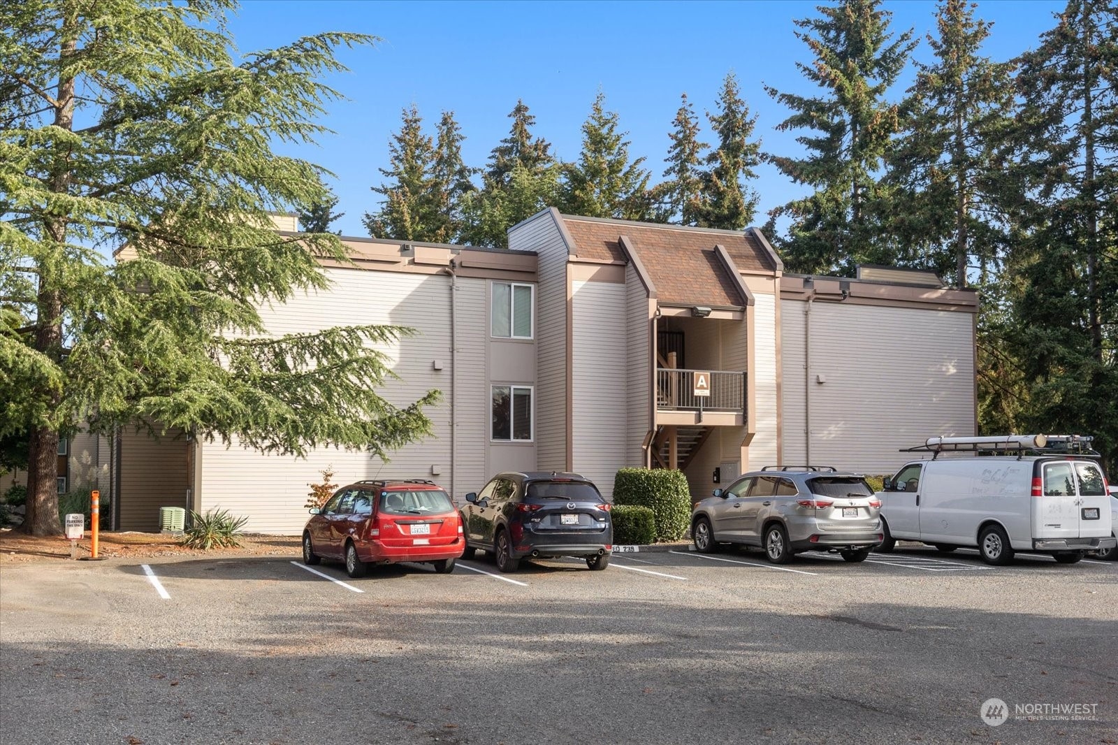 a view of a cars park in front of a house