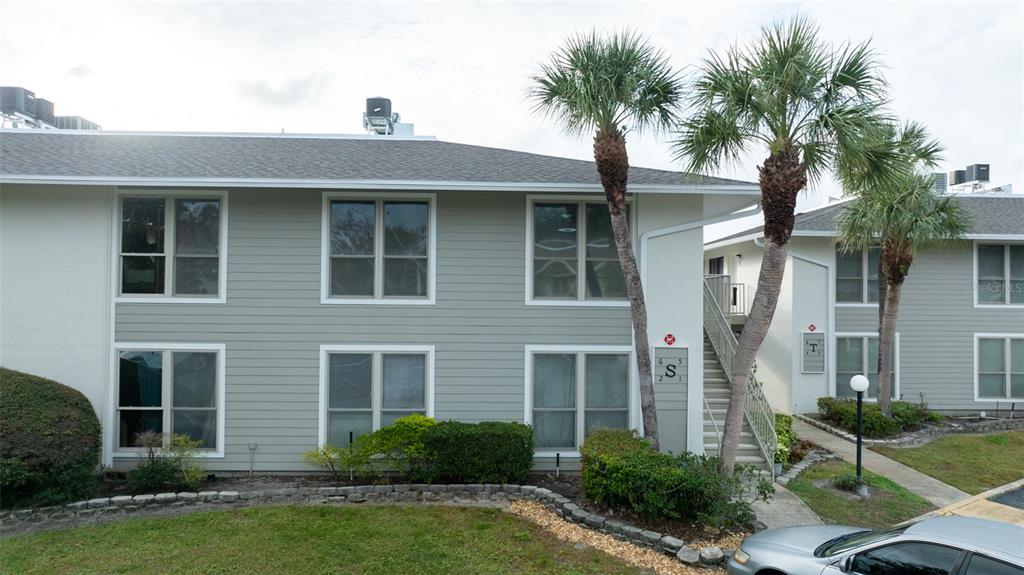 a front view of a house with yard and green space