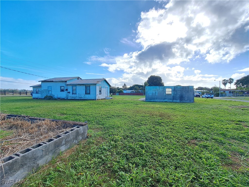 a view of a house with a yard and a garden