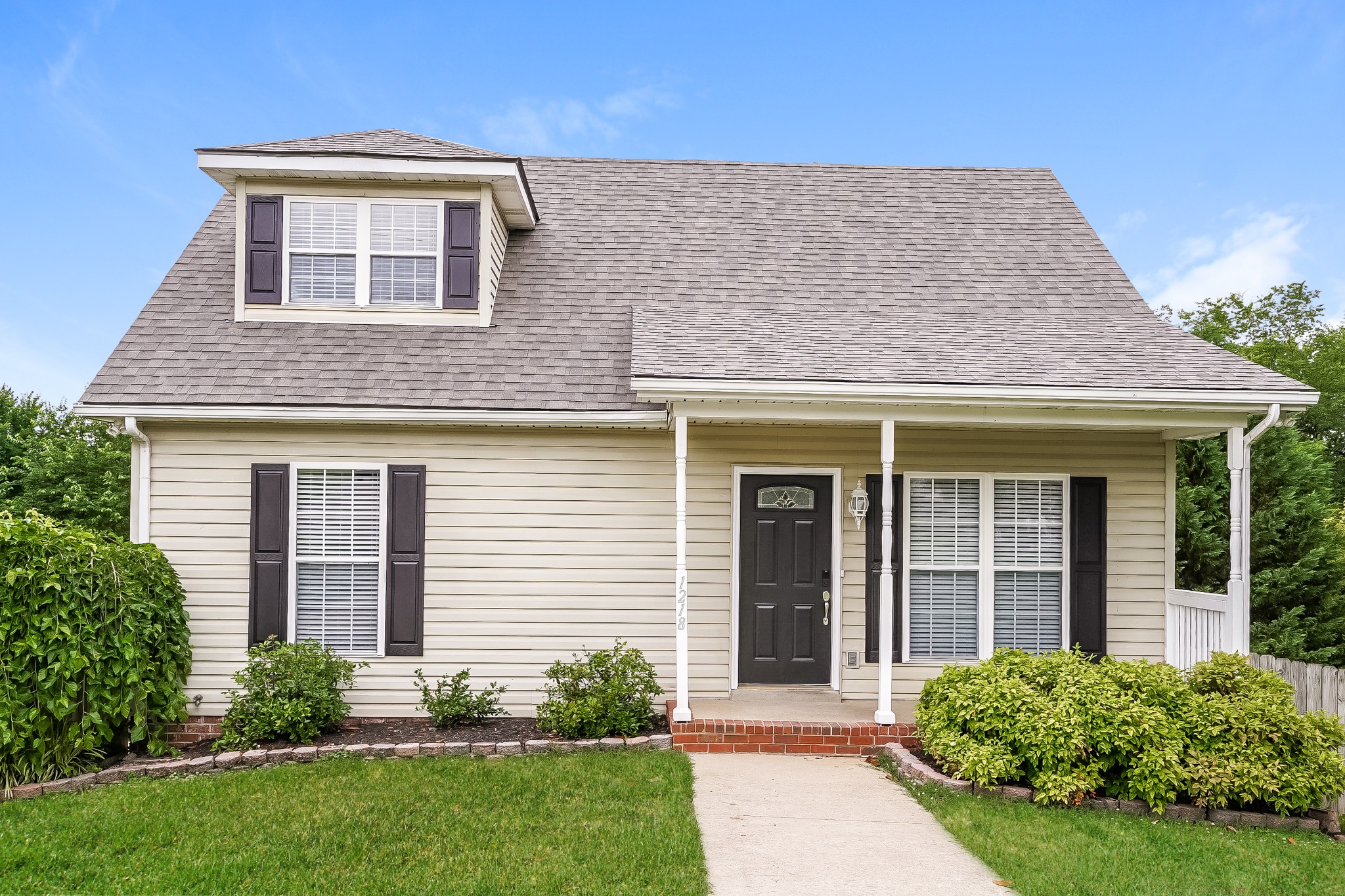 front view of a house with a yard