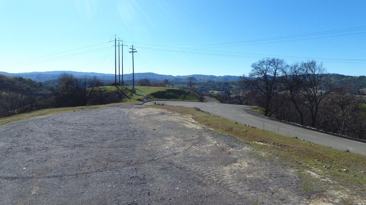 a view of a road with a dry yard