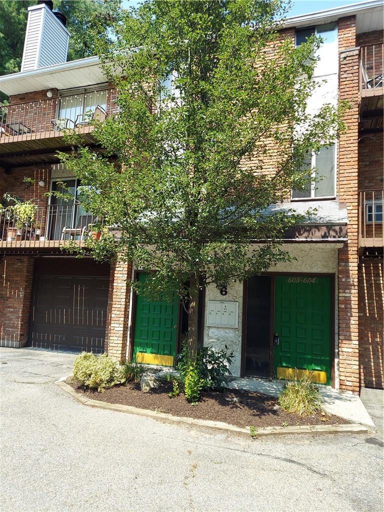 a front view of a house with a garden and garage