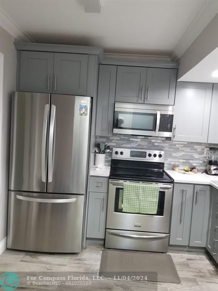 a kitchen with appliances and cabinets