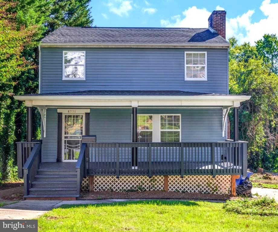 a view of a house with a wooden deck