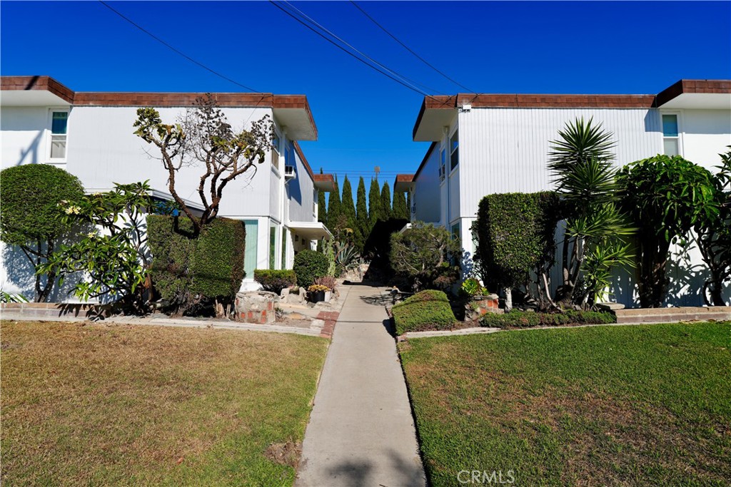 a view of a house with a swimming pool and a yard