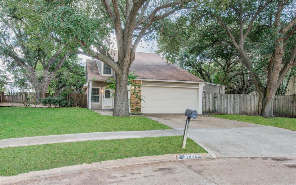 a house that has a tree in front of it