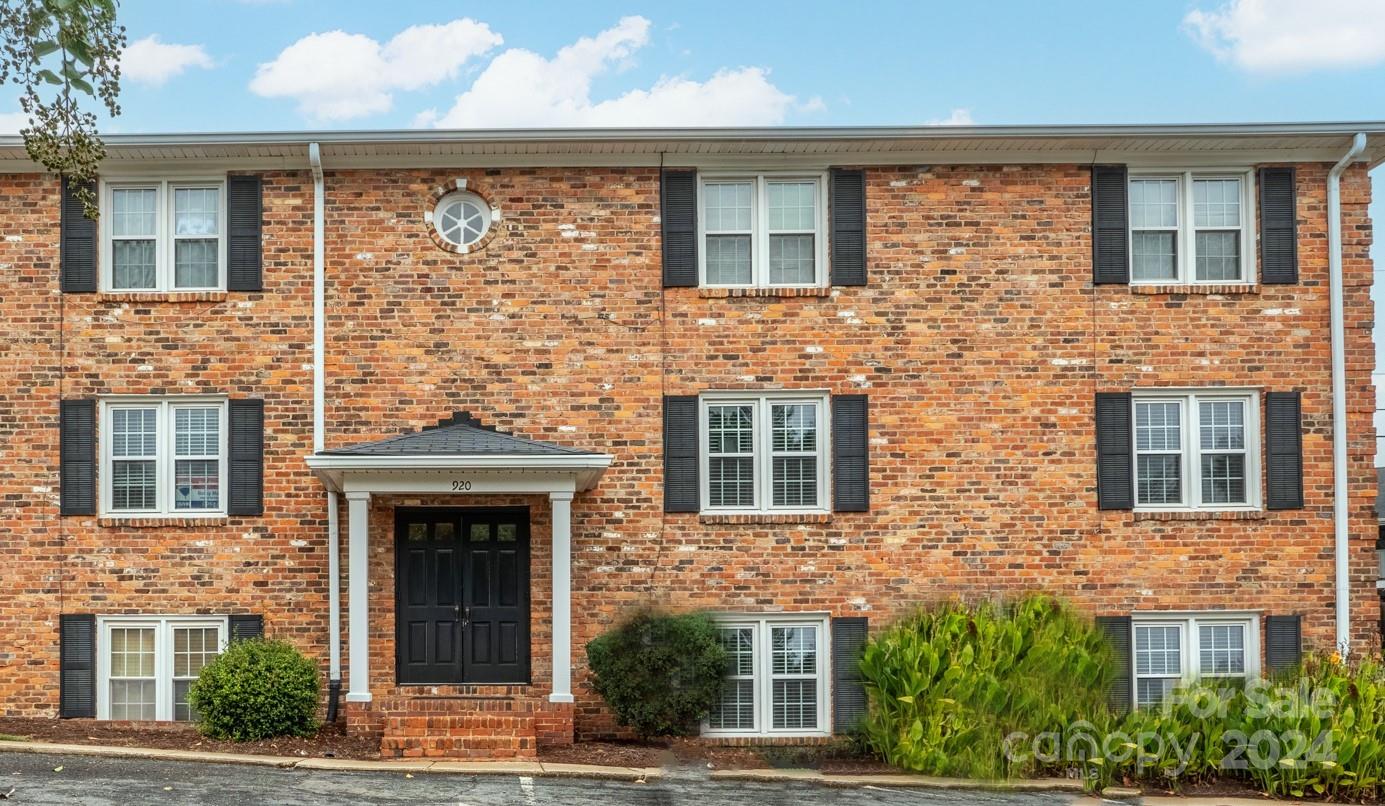 front view of a brick house with a windows