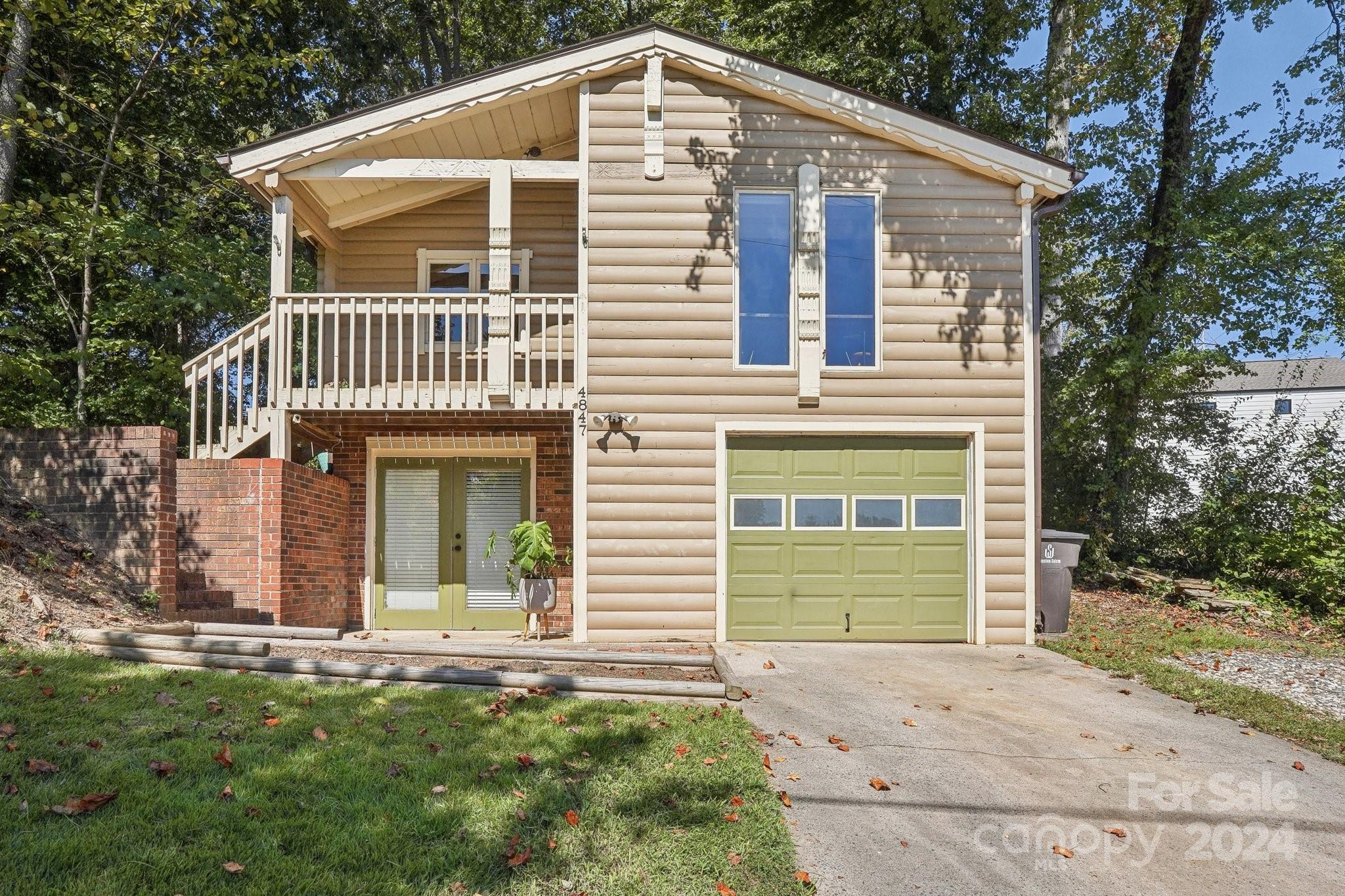 a front view of a house with a garden