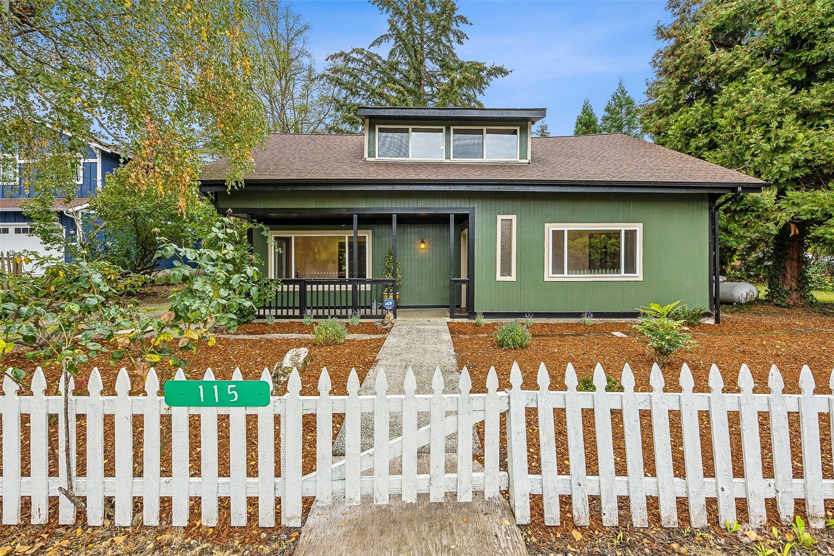 a front view of a house with a garden