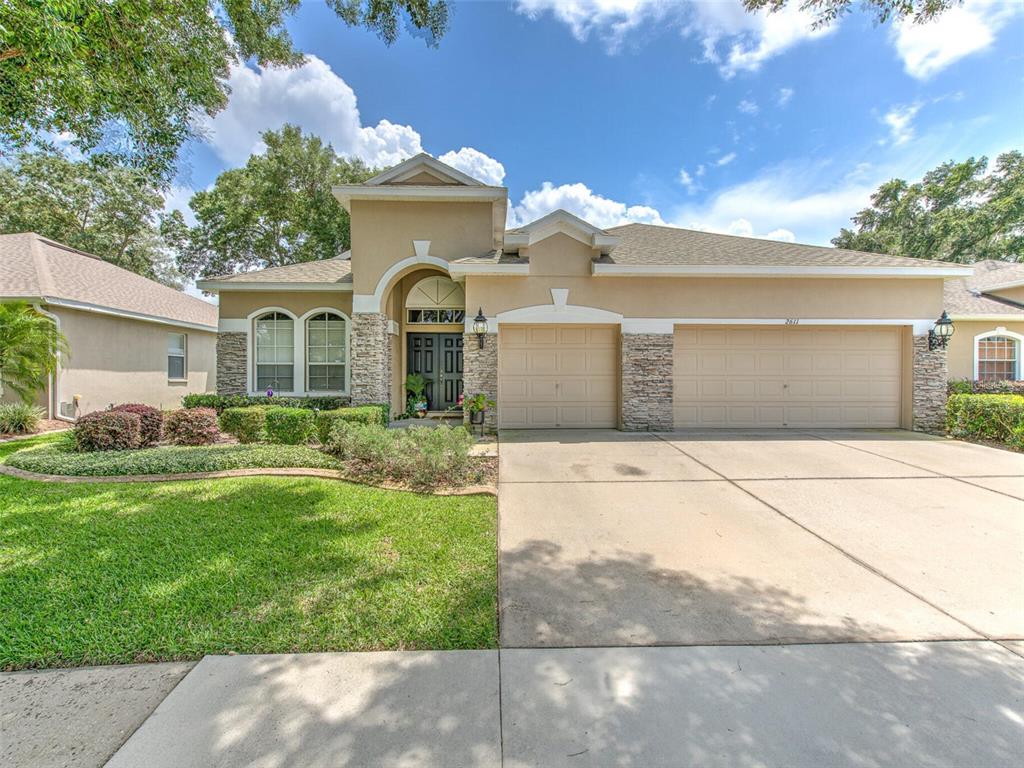 a front view of a house with a yard and a garage