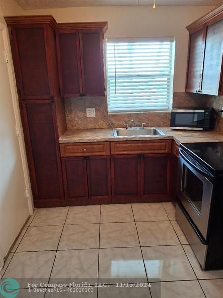 a kitchen with a cabinets and window