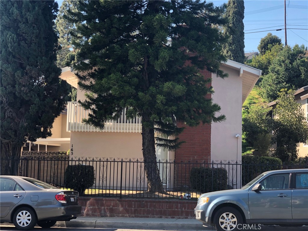 a front view of a house with parking area