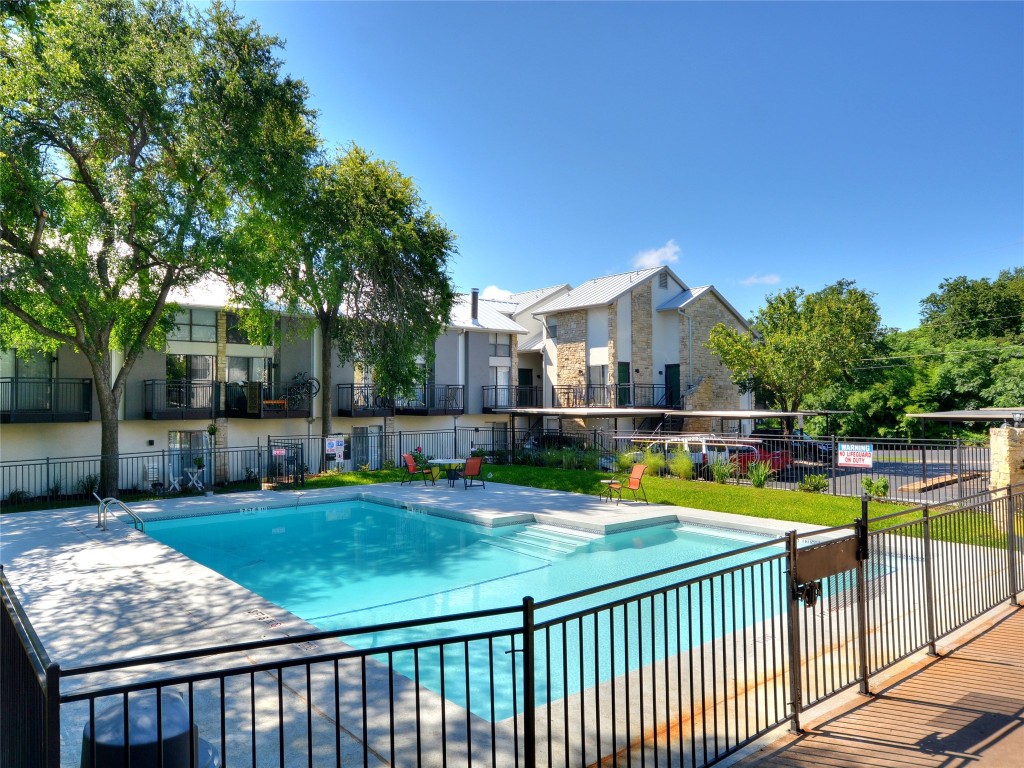 a view of a house with swimming pool and sitting area