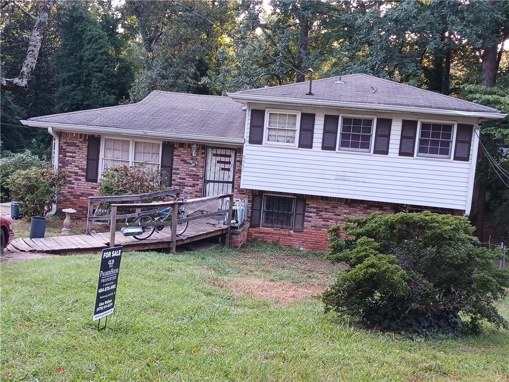 a front view of a house with a garden