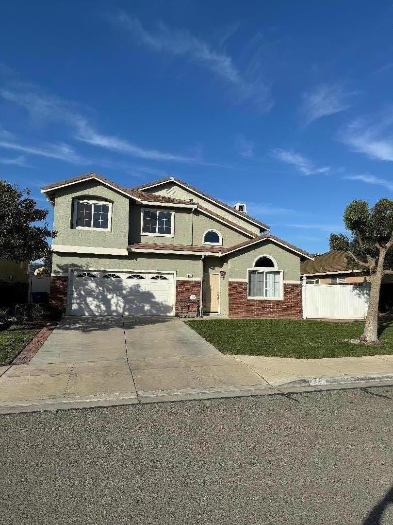 a front view of a house with a yard and garage