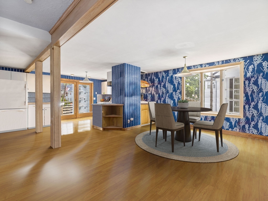 a dining room with furniture and wooden floor