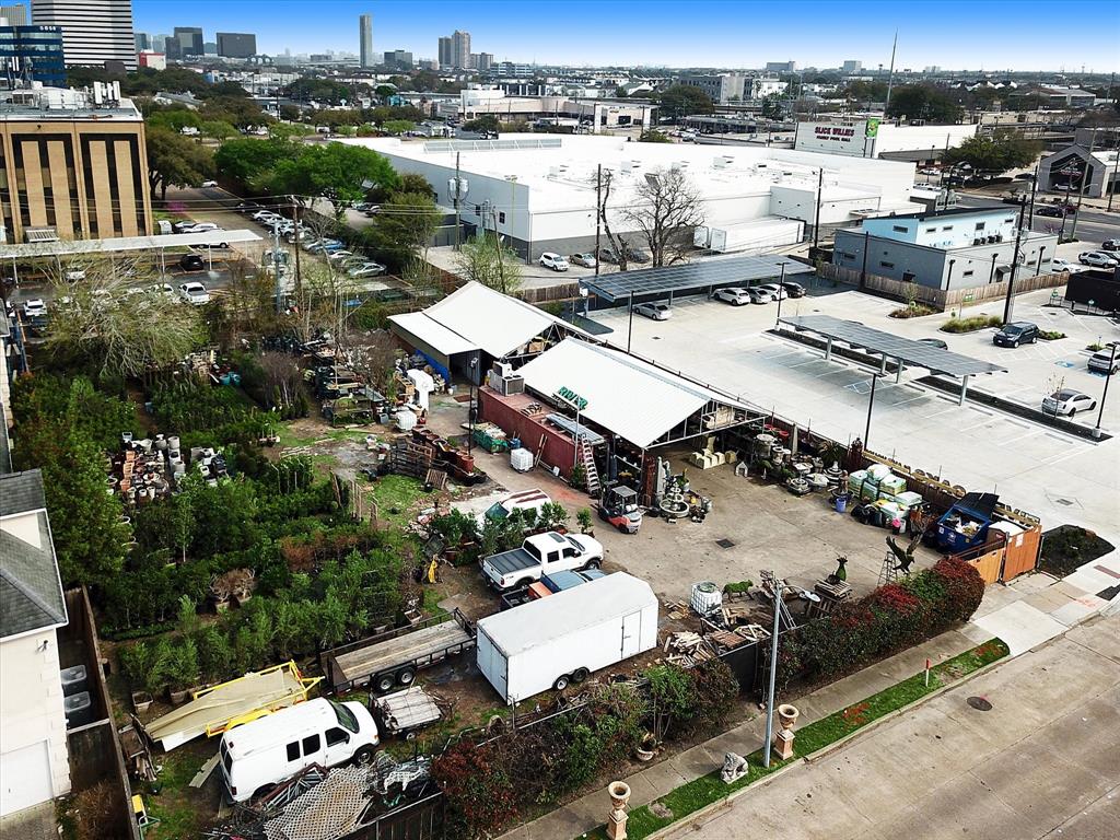 an aerial view of a house with a yard basket ball court and outdoor seating