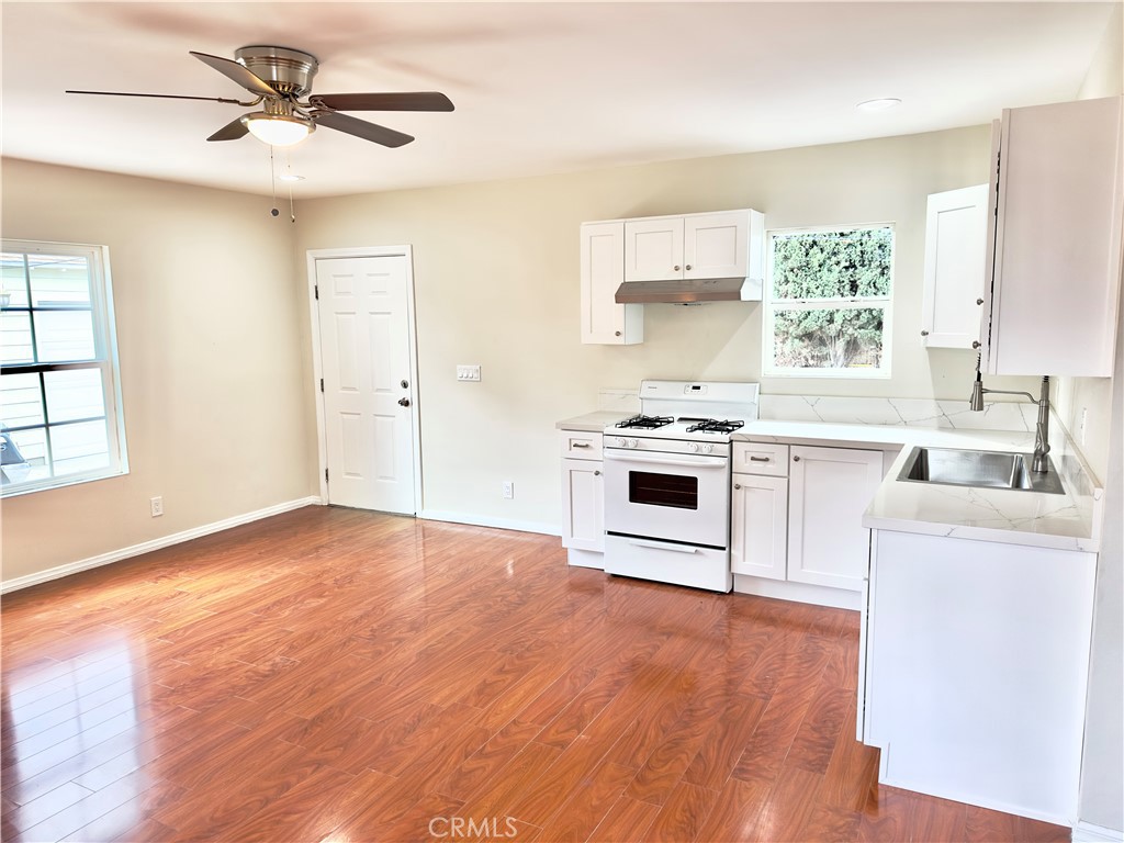 a kitchen with a stove a sink and a microwave