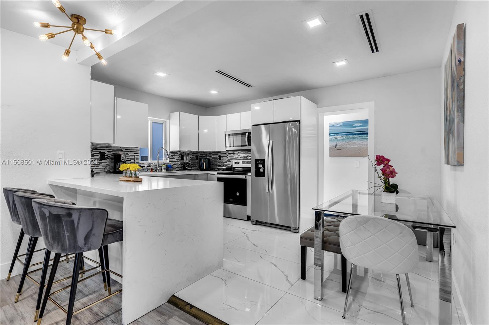 a kitchen with refrigerator and cabinets