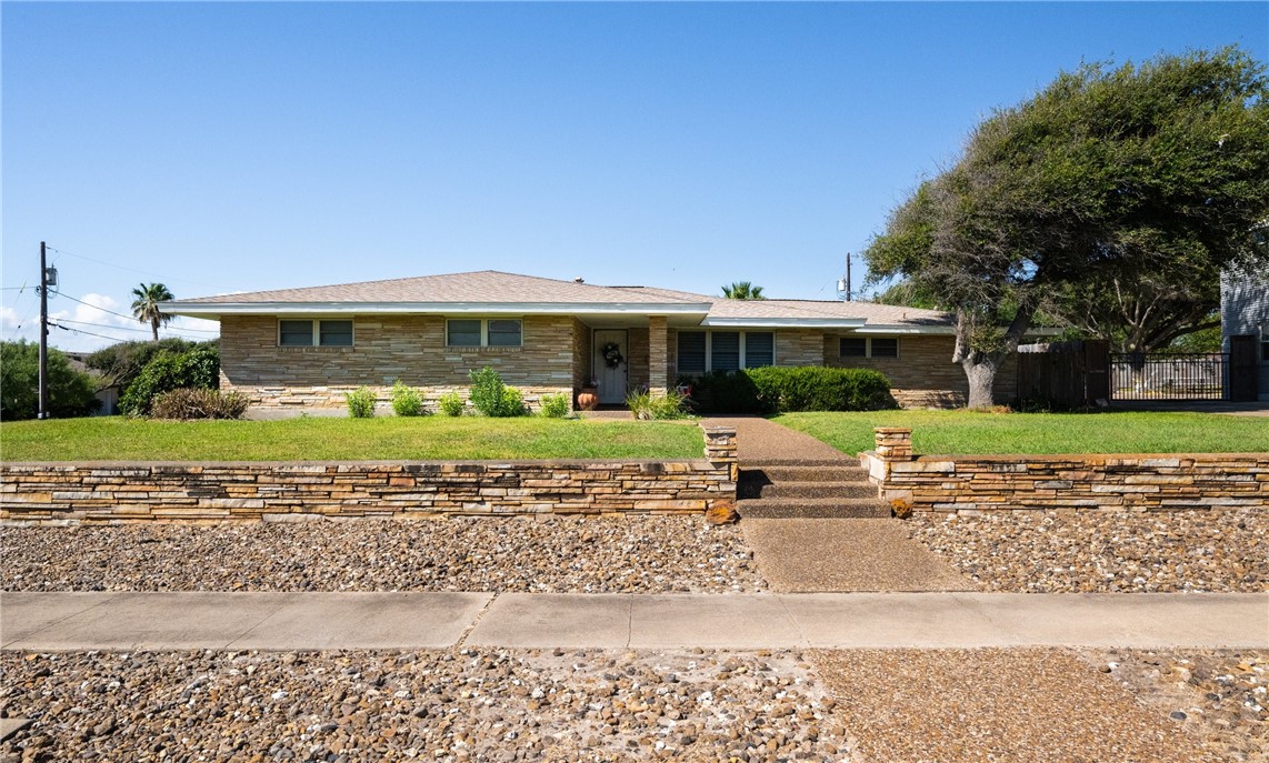 a front view of house with yard and green space