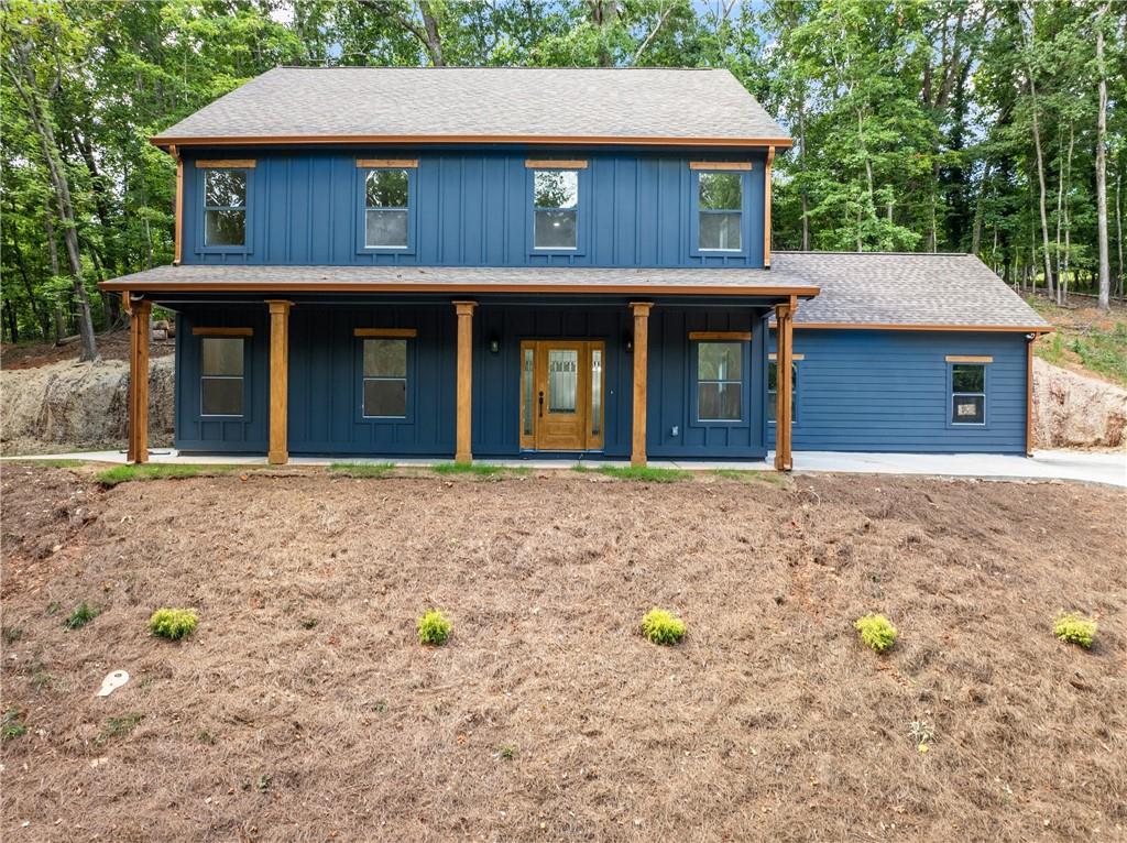 a front view of a house with a garden