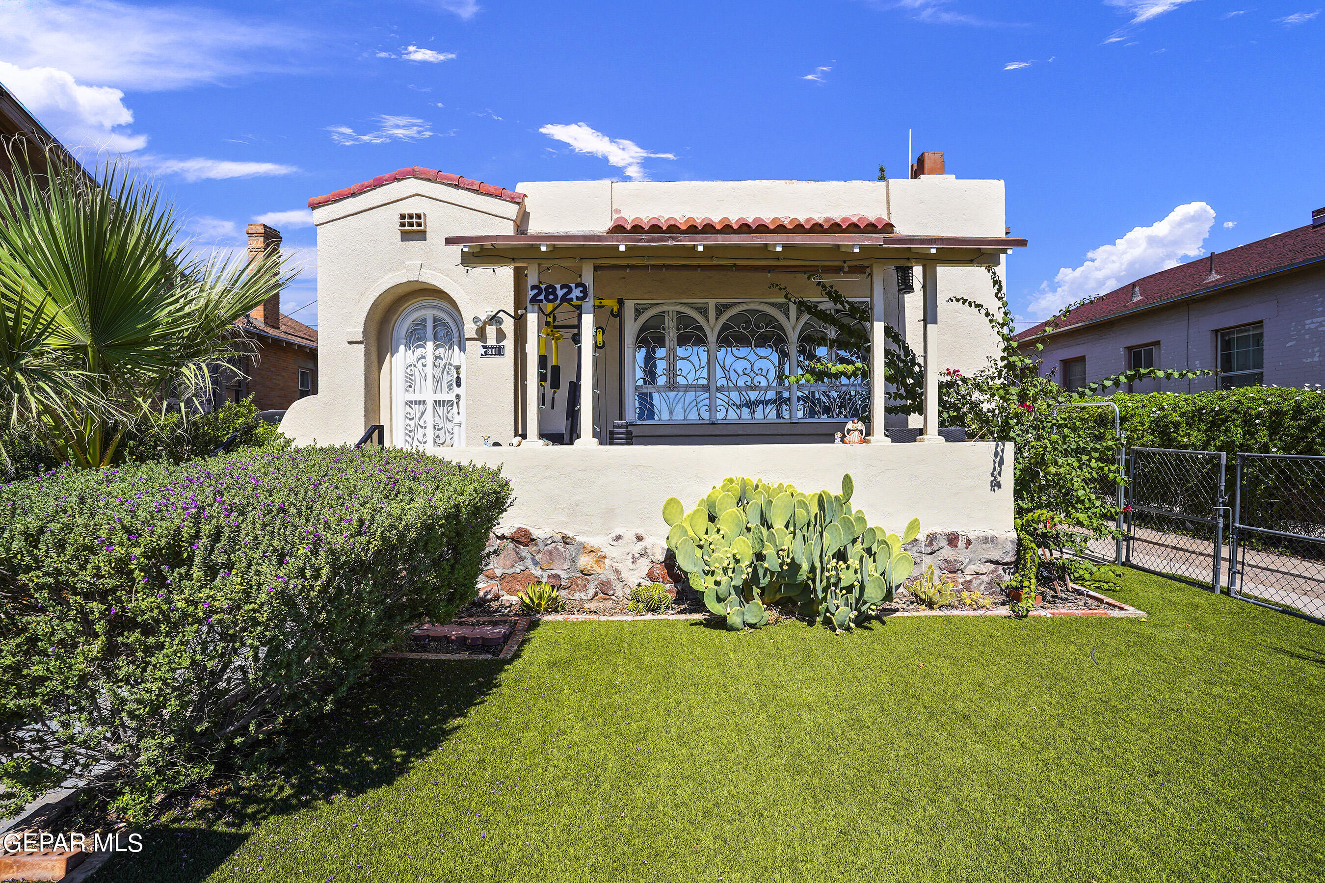 a front view of a house with a garden