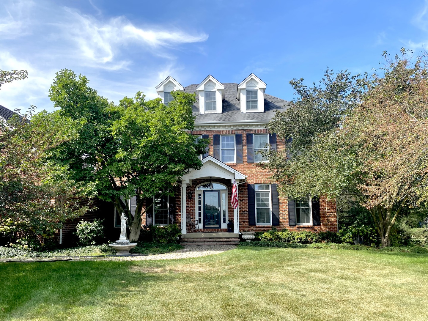 a front view of a house with a garden