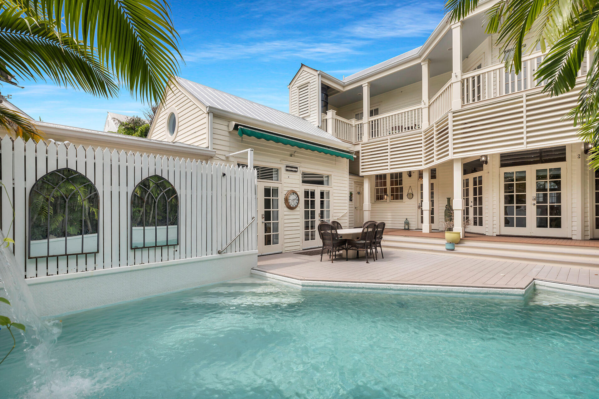 a view of a house with backyard and sitting area