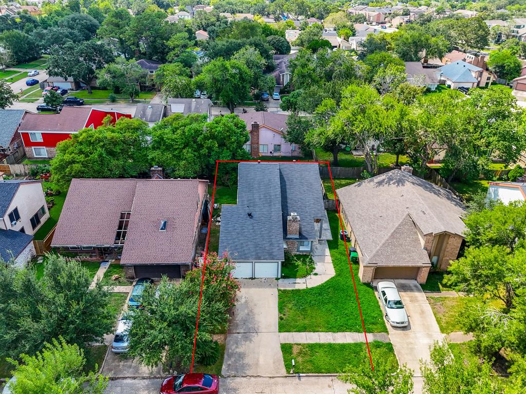 an aerial view of multiple houses with yard