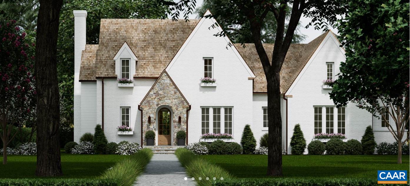 a view of a white house next to a yard with big trees