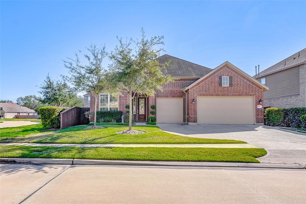 This beautiful home is located on a corner lot in the gated community of Pin Oak Enclave.