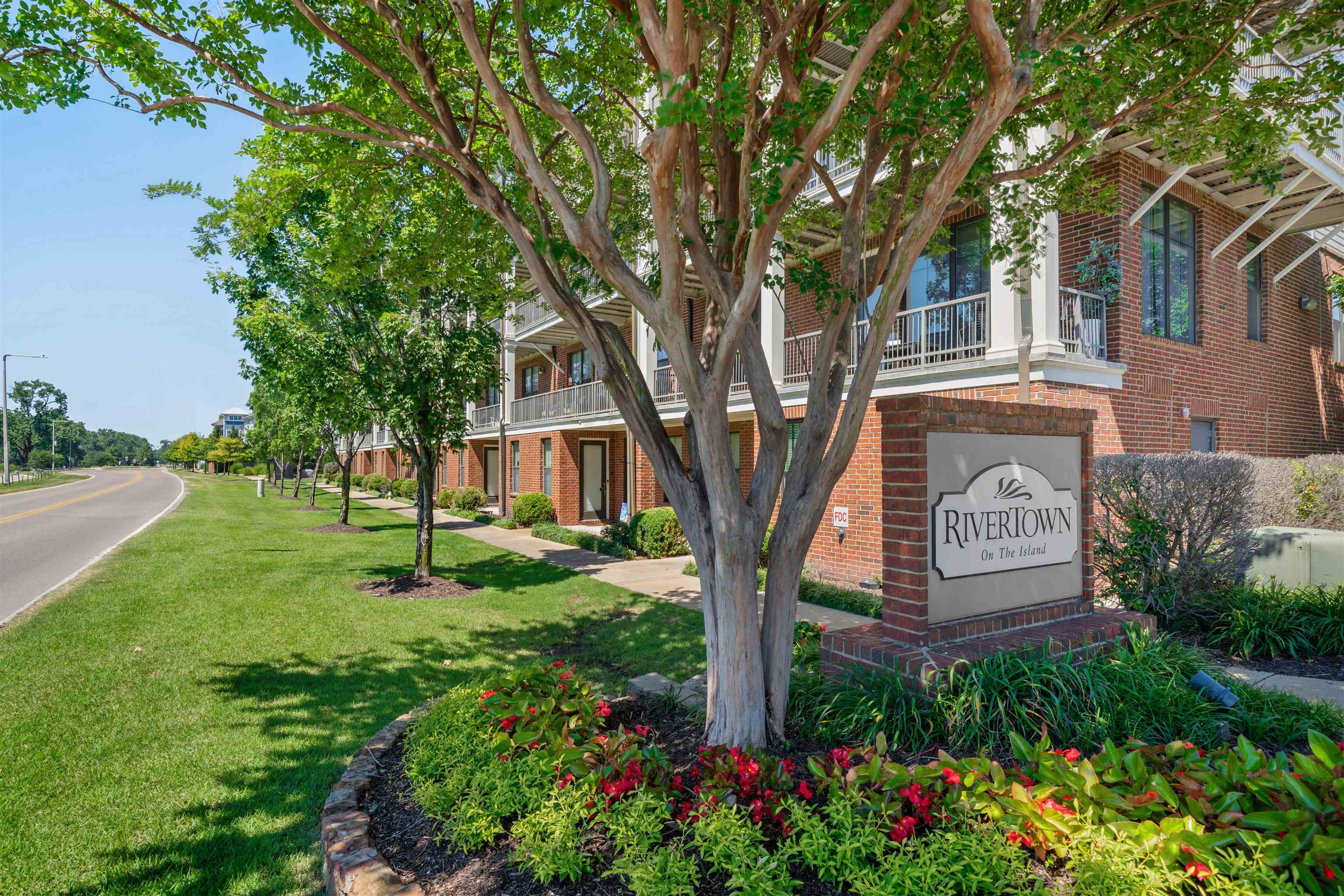 Condo building exterior with landscaping and lawn