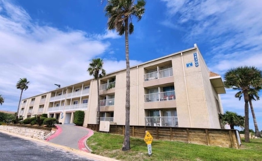 a front view of a building with garden