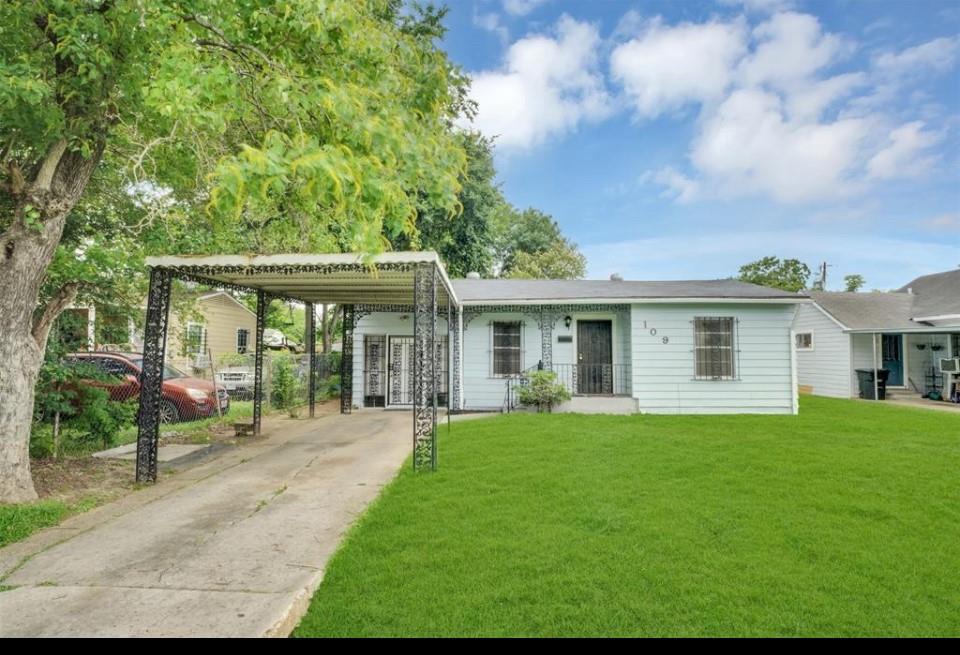 a front view of a house with a yard and porch