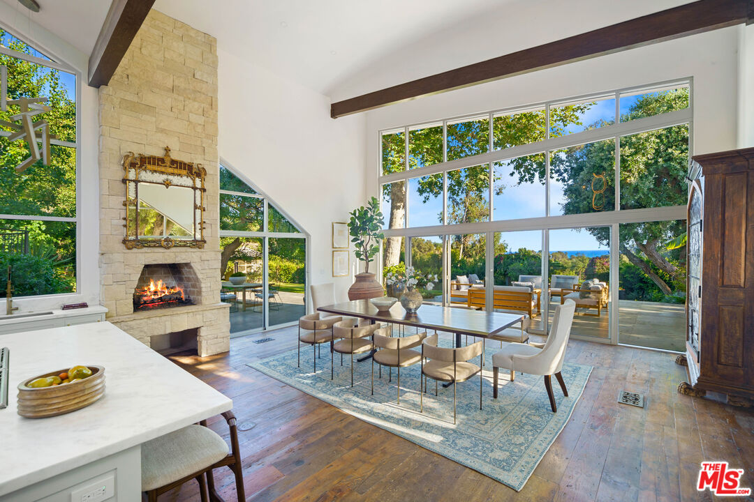 a living room with fireplace furniture and a large window