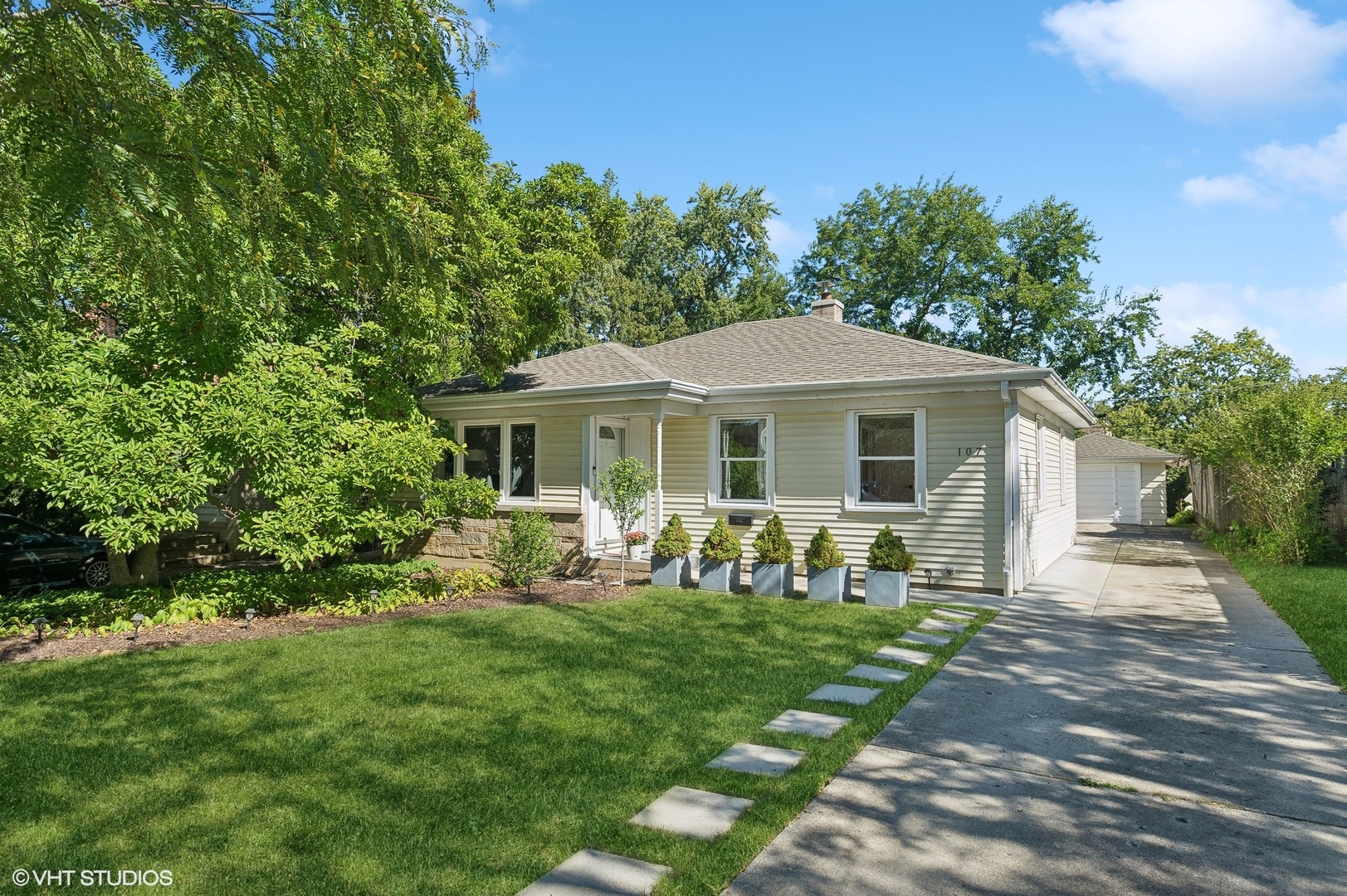 a front view of house with a garden and patio